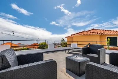 a patio with chairs and tables on a balcony at City Haven by Homie in Funchal