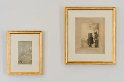 two framed pictures hanging on a white wall at Casa Ti'Rosa in Caniço