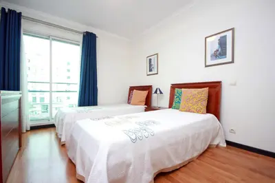 a bedroom with a bed and a large window at Forum Apartment by HR Madeira in Funchal