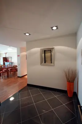 a room with a white wall and a vase on the floor at Forum Apartment by HR Madeira in Funchal