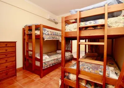 a room with three bunk beds in a room at Angela Beach Place in Vila Baleira