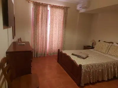 a bedroom with a bed and a dresser and a window at Angela Beach Place in Vila Baleira