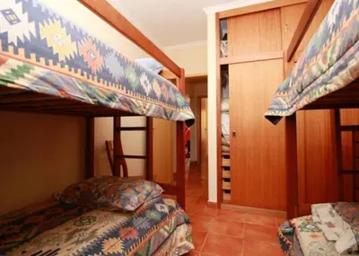 a bedroom with two bunk beds and a staircase at Angela Beach Place in Vila Baleira