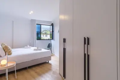 a bedroom with a bed and a refrigerator at GuestReady - The place to be happy in Madeira in Funchal