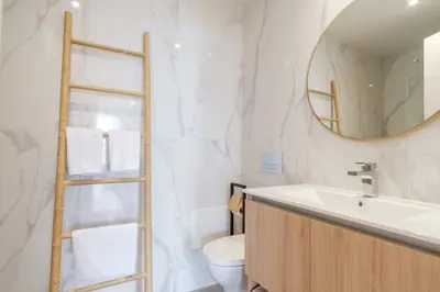 a bathroom with a sink and a mirror and a toilet at GuestReady - The place to be happy in Madeira in Funchal