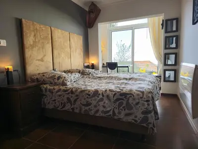 a bedroom with a bed and a large window at Horizon Retreat in Calheta