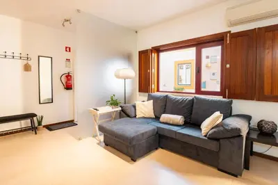 a living room with a couch and a window at Casa Da Bélgica in Sagres