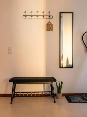 a bench sitting in a room with a mirror at Casa Da Bélgica in Sagres