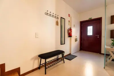 a room with a black stool in front of a door at Casa Da Bélgica in Sagres
