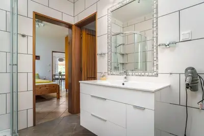 a bathroom with a sink and a mirror at Villa Fillmare in Lagos