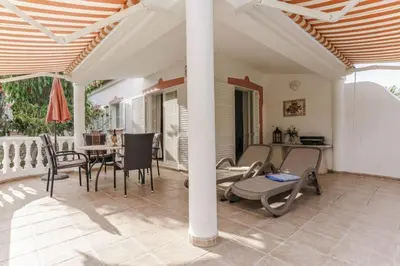 a patio with chairs and a table on a porch at Villa Fillmare in Lagos
