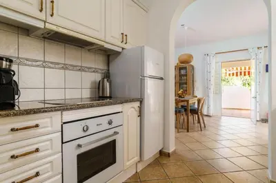a kitchen with a white refrigerator and a table at Villa Fillmare in Lagos