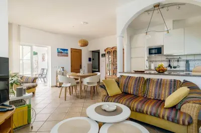 a living room with a couch and a kitchen at Villa Fillmare in Lagos