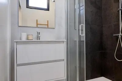 a bathroom with a shower with a glass door at Beco Santa Emilia 2I, a Home in Madeira in Funchal
