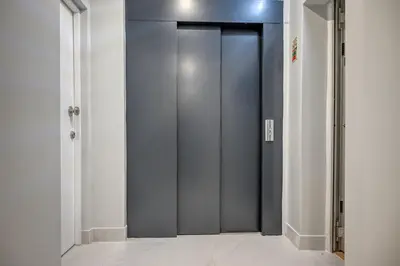 a gray elevator door in a white room at Beco Santa Emilia 2I, a Home in Madeira in Funchal
