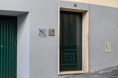a green door on the side of a building at Beco Santa Emilia 2I, a Home in Madeira in Funchal