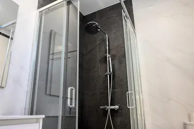 a shower with a glass door in a bathroom at Beco Santa Emilia 2I, a Home in Madeira in Funchal