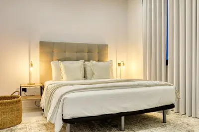 a bedroom with a large bed with white sheets and pillows at Beco Santa Emilia 2G, a Home in Madeira in Funchal