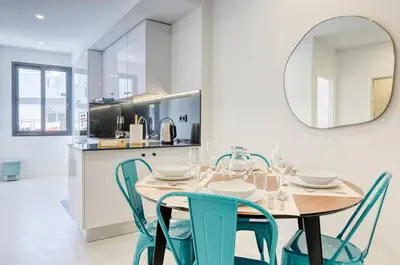 a dining room with a table and chairs and a mirror at Beco Santa Emilia 2G, a Home in Madeira in Funchal