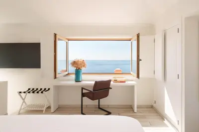 a bathroom with a sink and a tub and a window at Casa Pôr do Sal in Luz