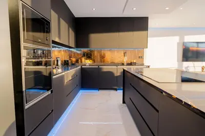 a kitchen with stainless steel appliances and black cabinets at Villa Luxe by Atlantic Holiday in Ribeira Brava