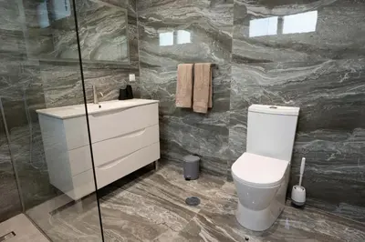 a bathroom with a toilet and a sink at Villa Luxe by Atlantic Holiday in Ribeira Brava