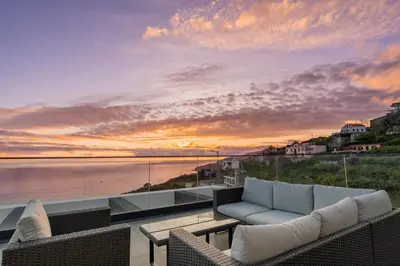 a living room with a couch and a view of the ocean at Villa Luxe by Atlantic Holiday in Ribeira Brava