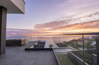 a view of the ocean from the balcony of a house at Villa Luxe by Atlantic Holiday in Ribeira Brava