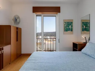 a living room with a blue couch and a table at Flat in Praia da Luz with Sea Views in Luz