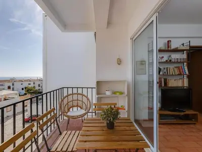 a balcony with a table and chairs and a view at Flat in Praia da Luz with Sea Views in Luz