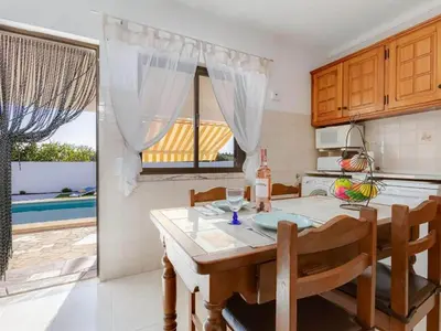 a small white house with a stone driveway at Casa Teresinha with private pool in Montinhos da Luz