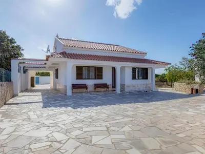 a swimming pool with blue chairs and a house at Casa Teresinha with private pool in Montinhos da Luz