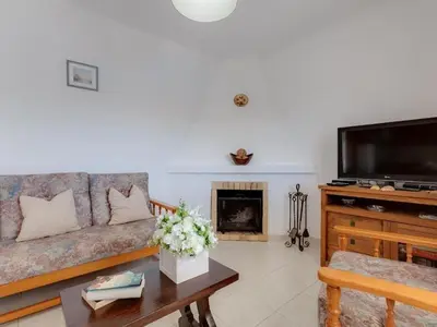 a bedroom with a bed and a dresser and a window at Casa Teresinha with private pool in Montinhos da Luz