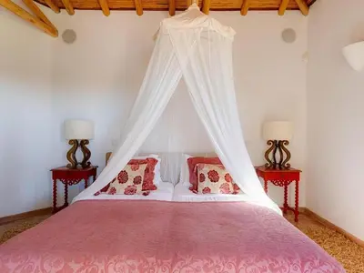a kitchen and dining room with a wooden table at Luxury villa with gym, jacuzzi and swimming pool in Lagos