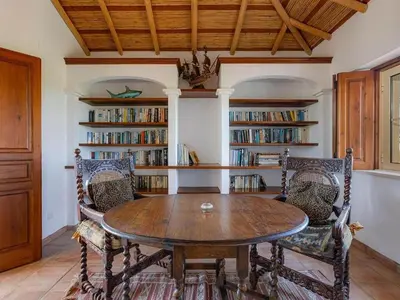 a patio with a glass table and wicker chairs at Luxury villa with gym, jacuzzi and swimming pool in Lagos