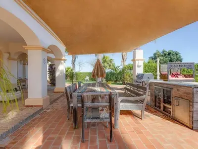 a dining room with a table and some books at Luxury villa with gym, jacuzzi and swimming pool in Lagos
