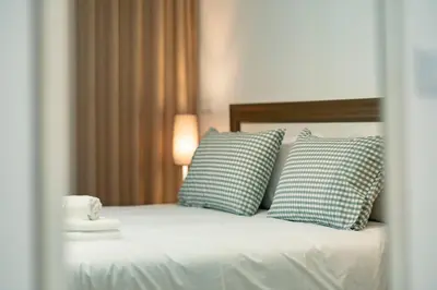 a bedroom with a bed with two pillows at Studios Funchal in Funchal