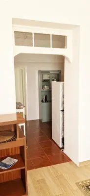 a kitchen with a refrigerator in a room at Apartamento renovado e luminoso a poucos minutos do centro in Funchal