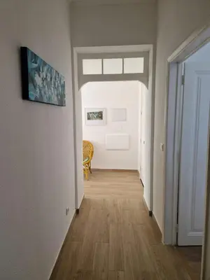 a hallway with a tripod in a room with a rug at Apartamento renovado e luminoso a poucos minutos do centro in Funchal