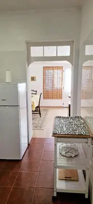a kitchen with a refrigerator and a counter top at Apartamento renovado e luminoso a poucos minutos do centro in Funchal