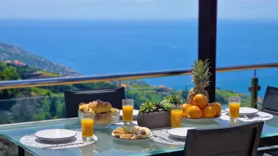 a table with fruit and juice on it with a view at Valley Miradouro View by LovelyStay in Ponta do Sol
