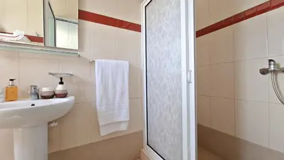 a white bathroom with a sink and a shower at Valley Miradouro View by LovelyStay in Ponta do Sol