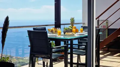 a table with food on top of a balcony at Valley Miradouro View by LovelyStay in Ponta do Sol