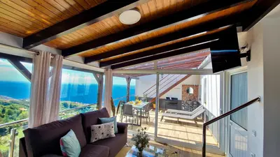 a living room with a couch and a view of the ocean at Valley Miradouro View by LovelyStay in Ponta do Sol