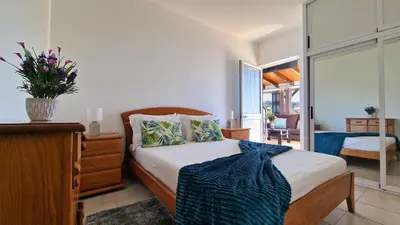 a bedroom with a bed and a bedroom with a window at Valley Miradouro View by LovelyStay in Ponta do Sol