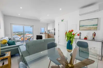 a living room with a couch and a glass table at The Look-Out Sagres in Sagres