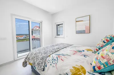 a bedroom with a bed and a window at The Look-Out Sagres in Sagres