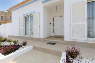 a white house with windows and a white door at Sunny Sagres in Sagres