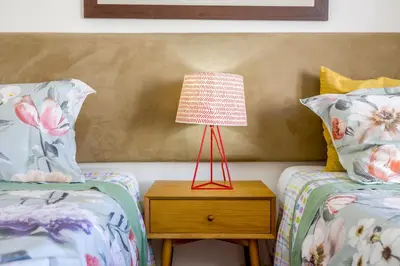 a bedroom with two beds and a lamp on a night stand at Sunny Sagres in Sagres