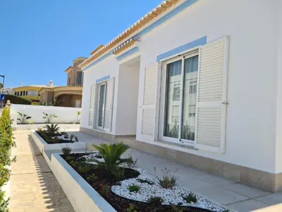 a white house with windows and plants at Sunny Sagres in Sagres